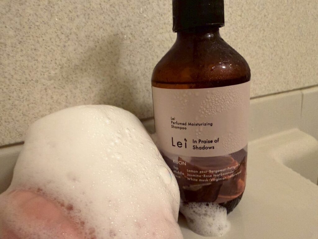 浴室で泡立てた手元とLei Perfumed Moisturizing Shampoo(KUON)のボトル