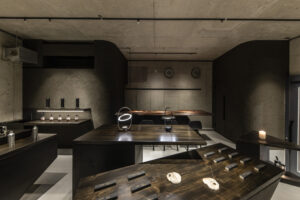 Interior view of the Lei In Praise of Shadows Flagship Store with urushi-finished tabletops and displayed products