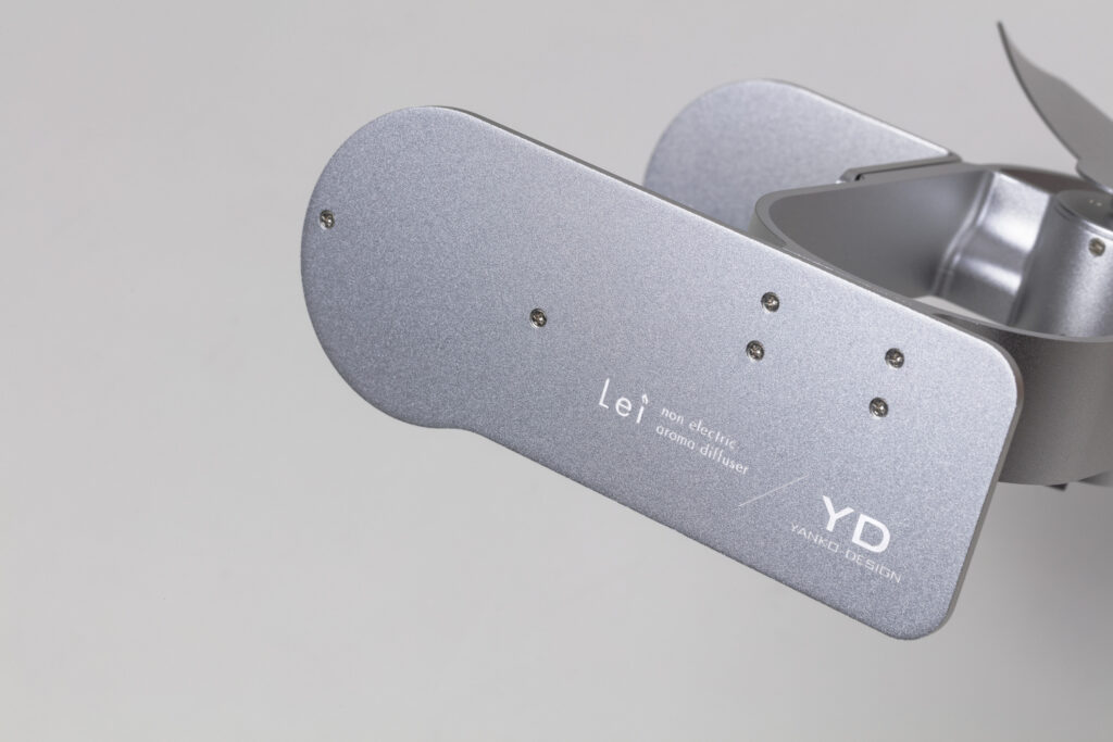 The Lei logo and the YD YANKO DESIGN logo on the body plate of the Silver Lei non electric aroma diffuser.